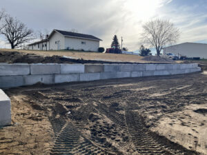 Excavation work and retaining wall construction on a graded site.
