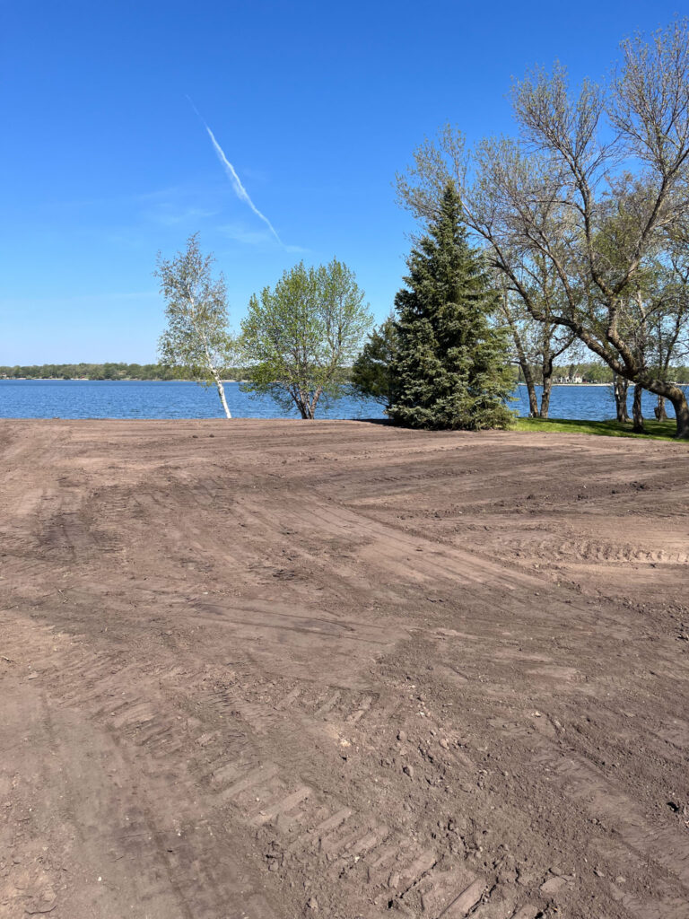 Excavated property with lake in the background.
