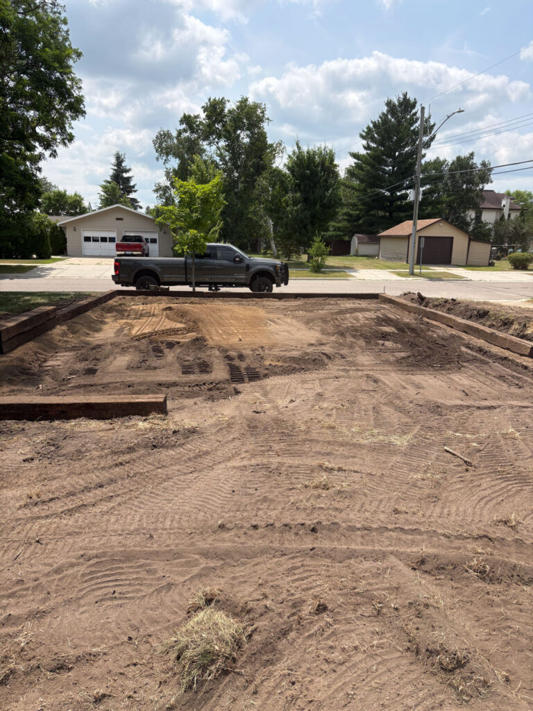 Rectangular section flattened with a car parked on the road.