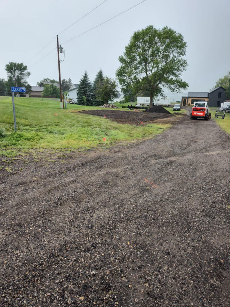 Driveway with car on excavated path.