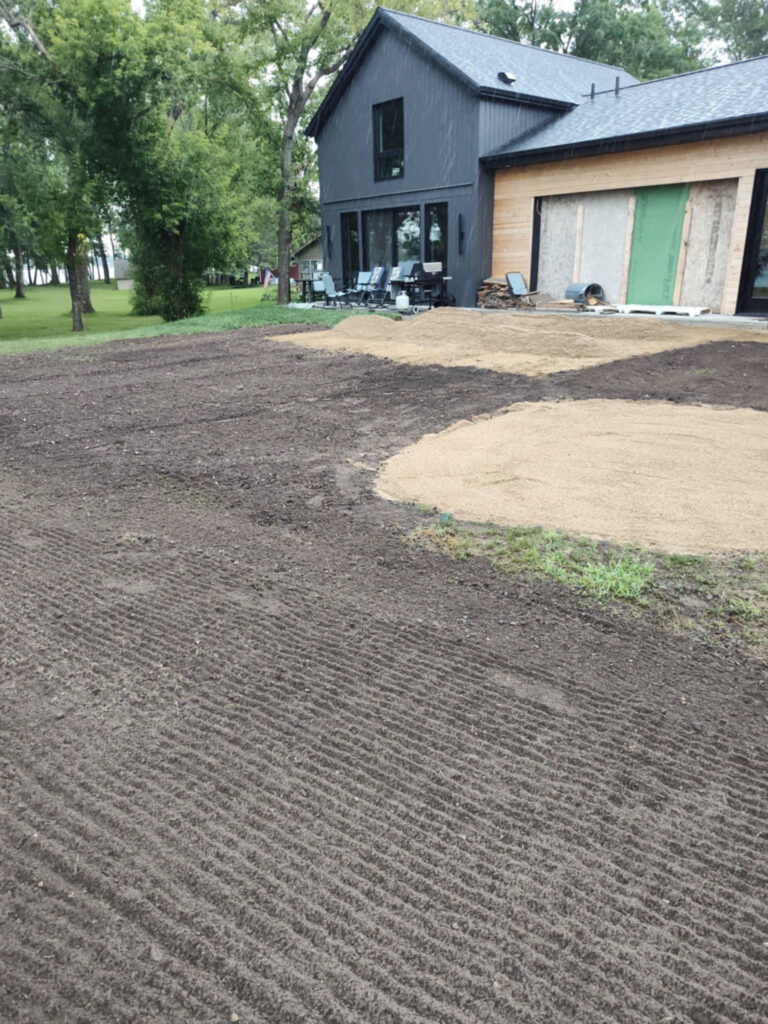 House with excavating work done around the garage.