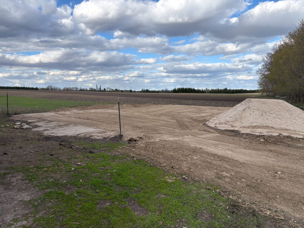 Flat ground with a dirt pile next to it
